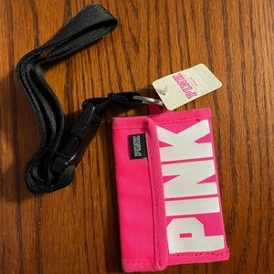 PINK lanyard with card holder. Never been used. Tag still attached.